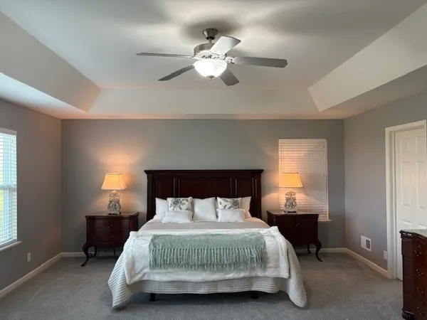 a bedroom with a bed and a chandelier