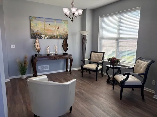 a living room with furniture and a chandelier