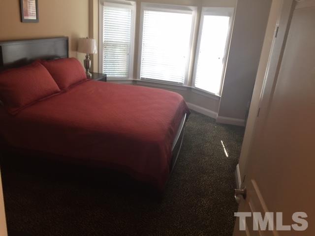 7510 Lead Mine Road, Unit 106 Raleigh, NC 27615 - Photo 11 of 22 a bedroom with a bed and a window