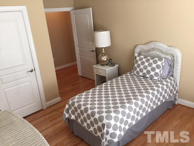 7510 Lead Mine Road, Unit 106 Raleigh, NC 27615 - Photo 13 of 22 a large bed sitting in a bedroom next to a window