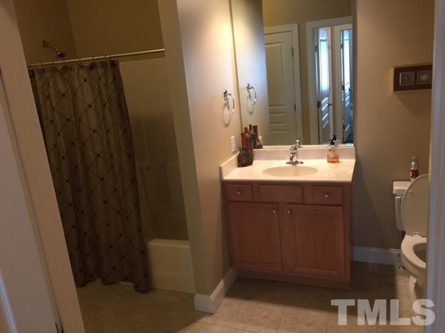 7510 Lead Mine Road, Unit 106 Raleigh, NC 27615 - Photo 15 of 22 a bathroom with sink shower and mirror