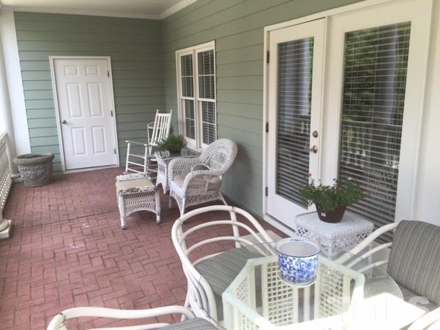 7510 Lead Mine Road, Unit 106 Raleigh, NC 27615 - Photo 18 of 22 a view of a dinning tables and chair in the patio