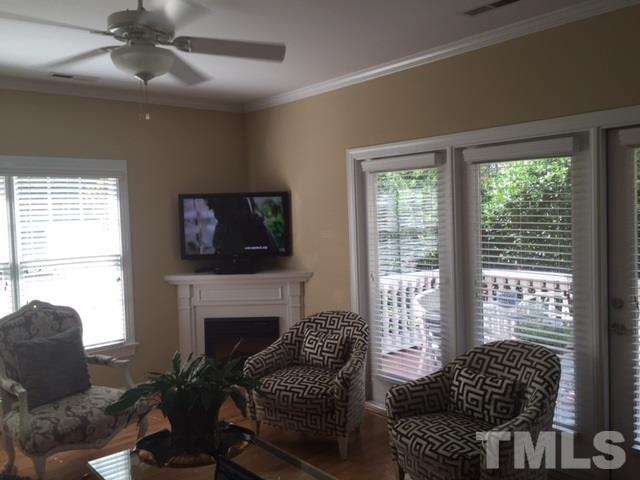 7510 Lead Mine Road, Unit 106 Raleigh, NC 27615 - Photo 6 of 22 a living room with furniture a fireplace and a flat screen tv