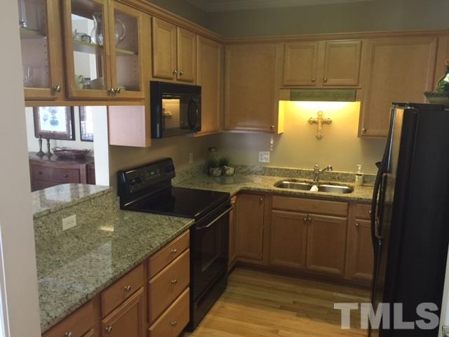 7510 Lead Mine Road, Unit 106 Raleigh, NC 27615 - Photo 8 of 22 a kitchen with granite countertop a sink stove and refrigerator