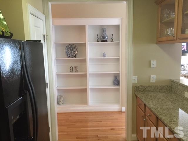 7510 Lead Mine Road, Unit 106 Raleigh, NC 27615 - Photo 9 of 22 a view of kitchen island with cabinets and wooden floor