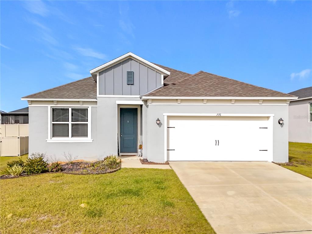 776 Rioja Drive Minneola, FL 34715 - Photo 1 of 1 a front view of a house with yard and garage