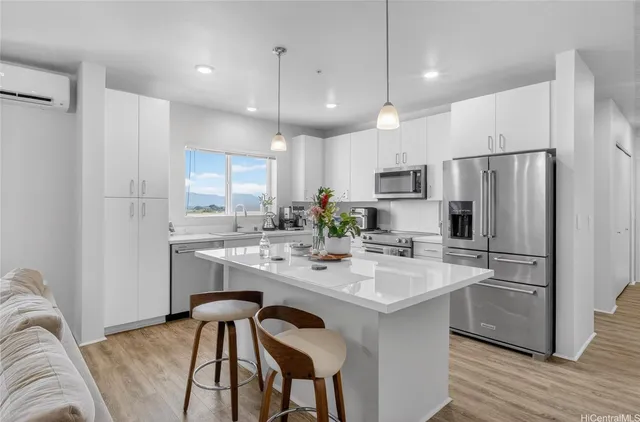 a kitchen with a sink stove top oven and cabinets