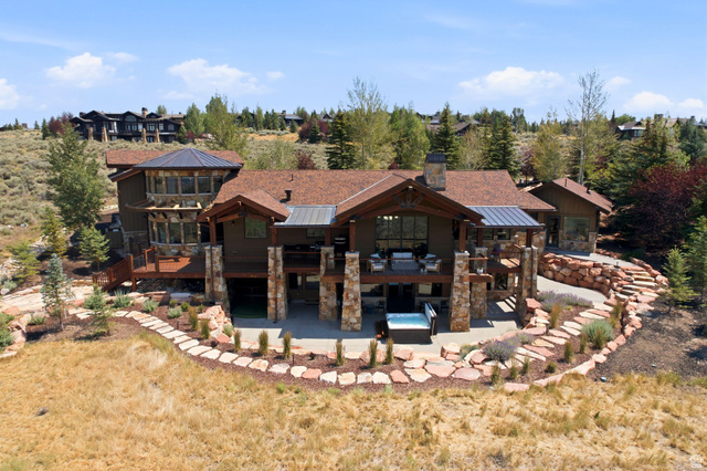 7885 North Rabbitbrush Court, Unit 13 Park City, UT 84098 - Photo 83 of 88 Spacious multi-level property with stone and wood siding, featuring multiple balconies, a ground-level patio, and an integrated hot tub