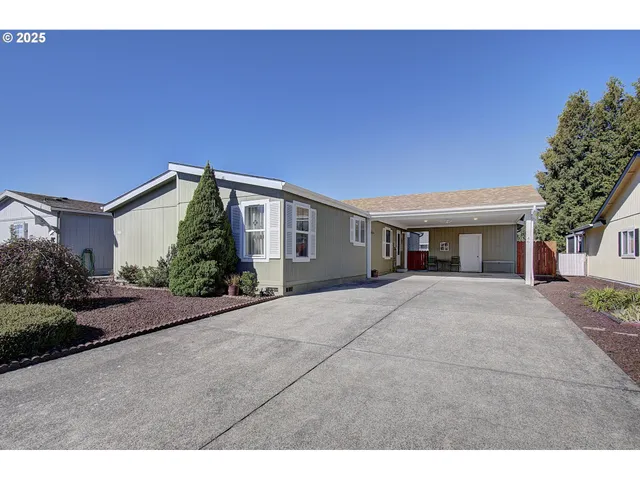 a front view of a house with a yard and a garage