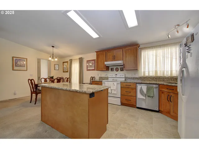 a kitchen with refrigerator and cabinets
