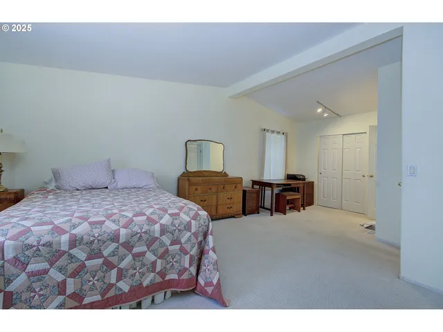 a en suite bathroom with a granite countertop sink a mirror and a