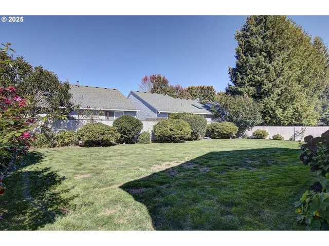 a view of a house with backyard and sitting area