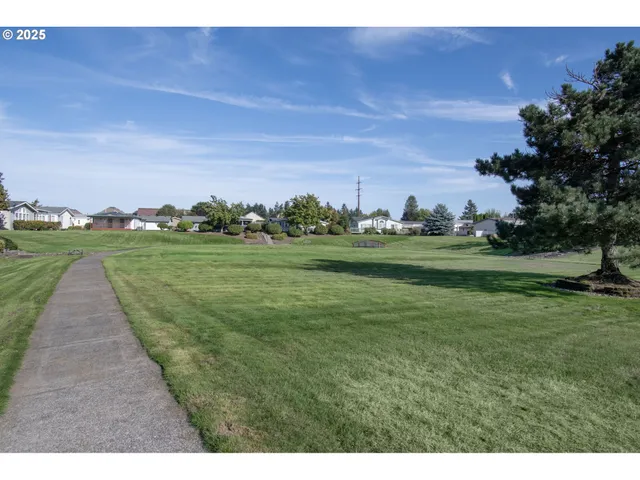 a view of a golf course with outside space