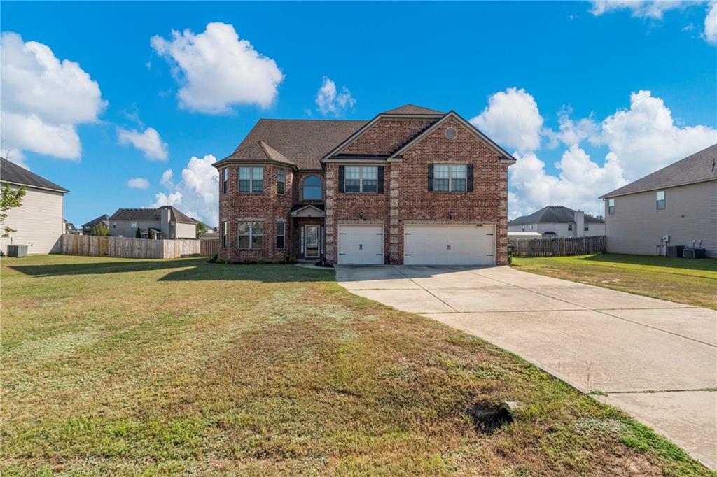 12 Juno Street Fort Mitchell, AL 36856 - Photo 1 of 43 Traditional home with brick siding, an attached garage, and driveway