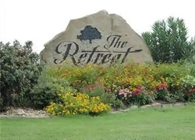 a view of a sign board with yard