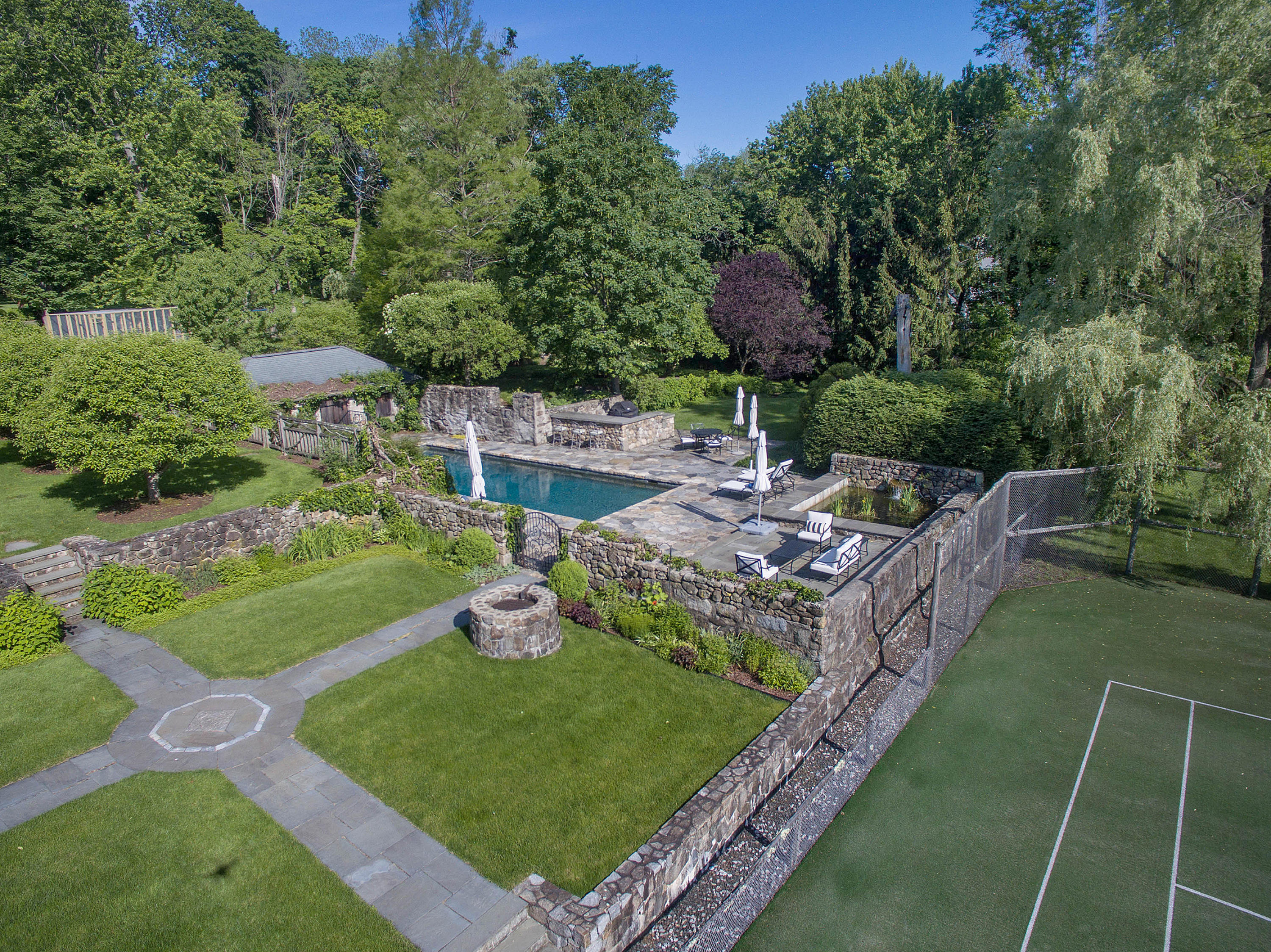 314 Brushy Ridge Road New Canaan, CT 06840 - Photo 13 of 23 a view of a house with a yard