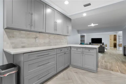 a kitchen with sink cabinets and microwave