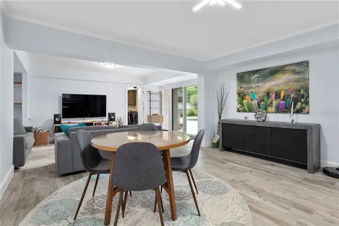 a living room with furniture a flat screen tv and a kitchen view