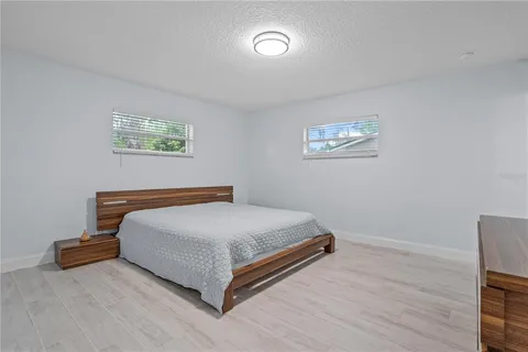 a bedroom with a bed and a night stand