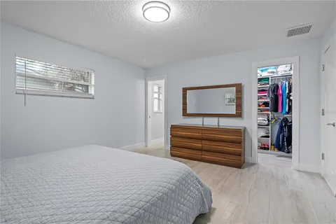 a bedroom with a bed and a dresser