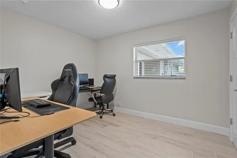 a view of a workspace with furniture and a window