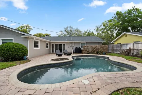 a view of a house with swimming pool and sitting area