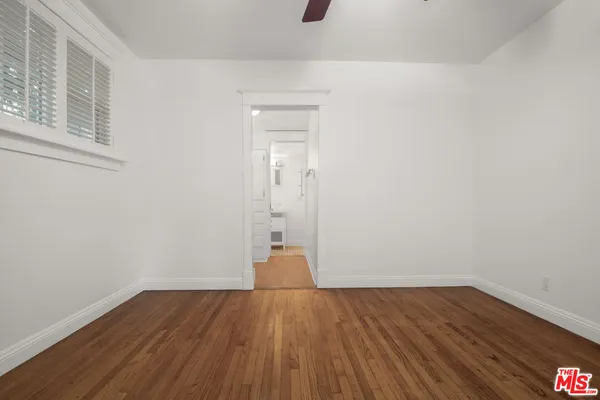 a view of wooden floor and windows in a room