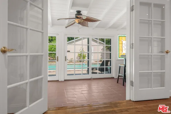 a view of a livingroom with wooden floor and a window
