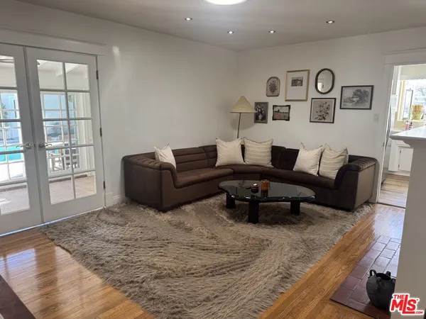 a living room with furniture window and wooden floor