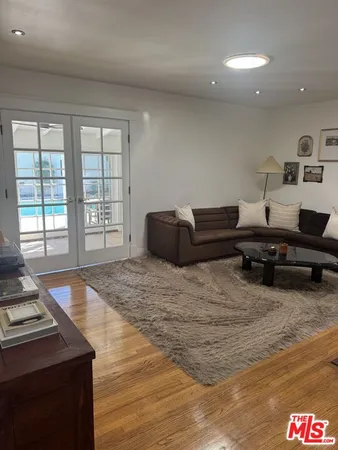 a living room with furniture and a floor to ceiling window