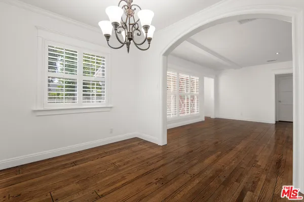 a view of wooden floor and windows in a room