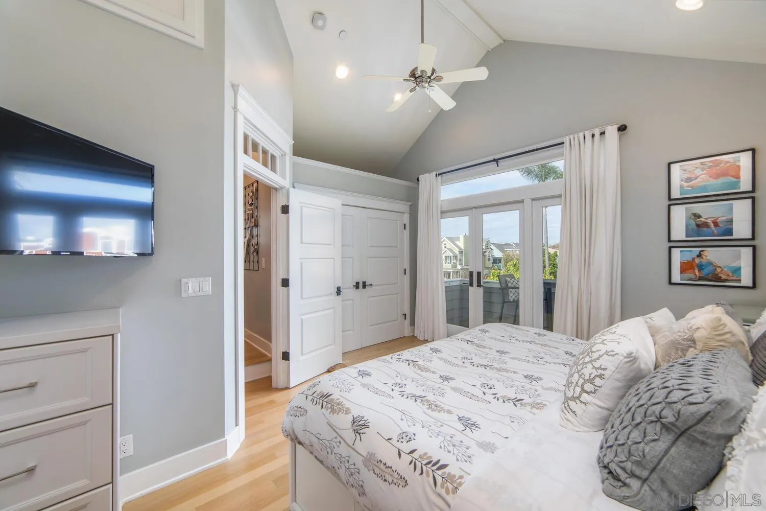 717 G Avenue Coronado, CA 92118 - Photo 17 of 33 a bedroom with a large bed and a chandelier