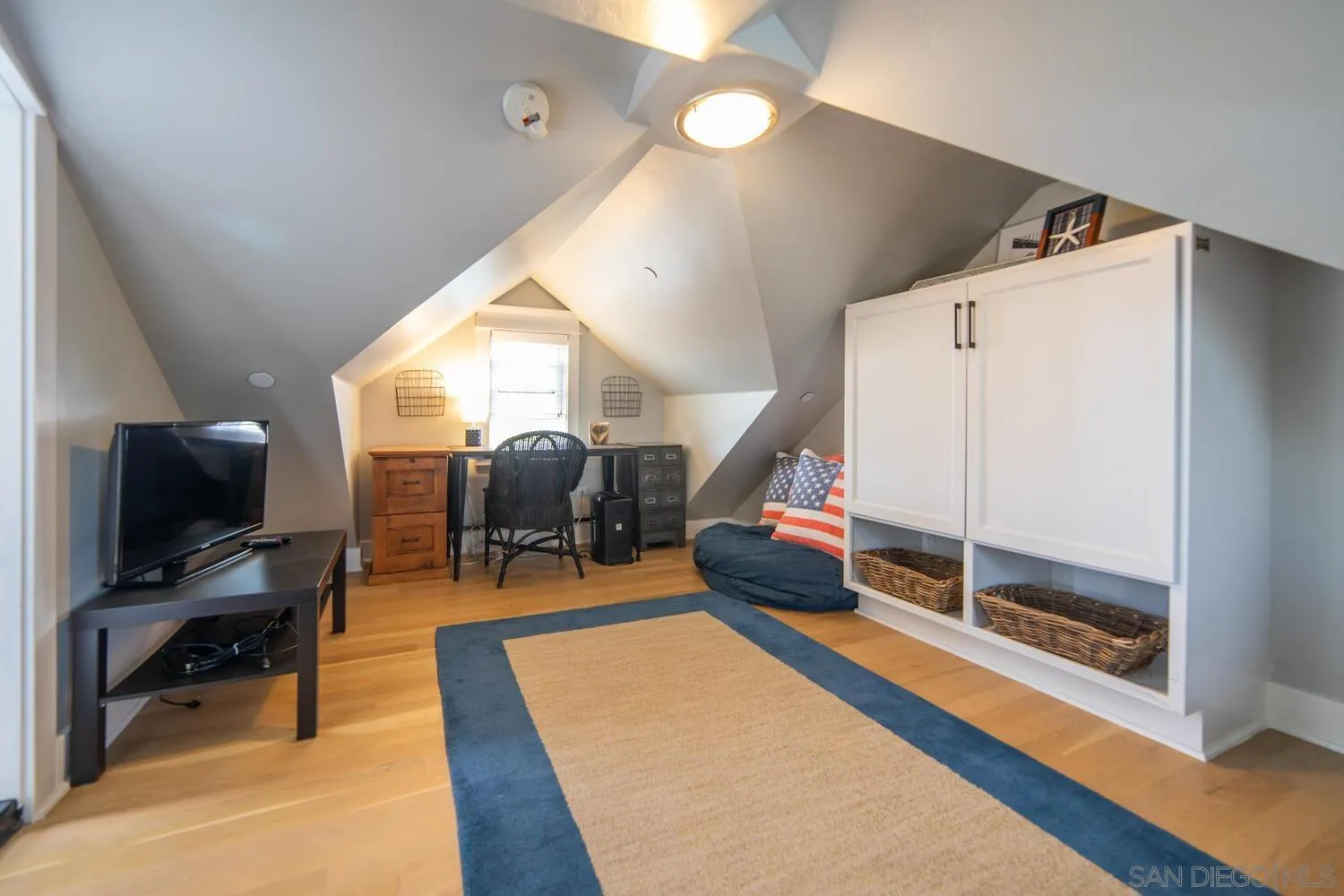 717 G Avenue Coronado, CA 92118 - Photo 22 of 33 a living room with furniture a flat screen tv and a large window
