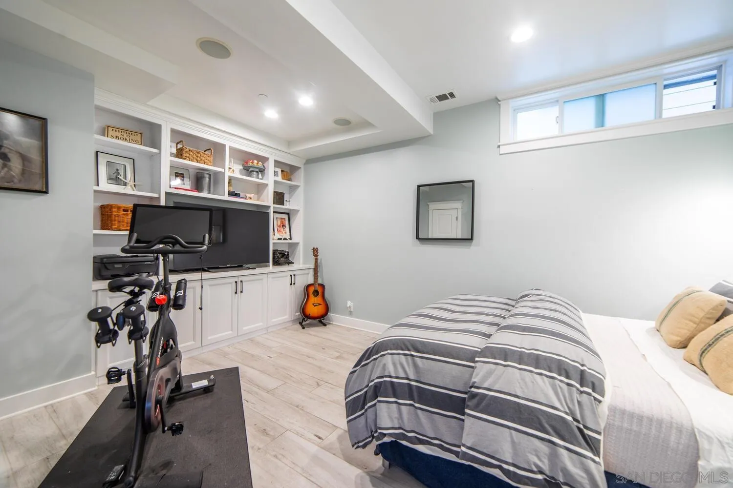 717 G Avenue Coronado, CA 92118 - Photo 27 of 33 a bedroom with a bed a flat screen tv and a window