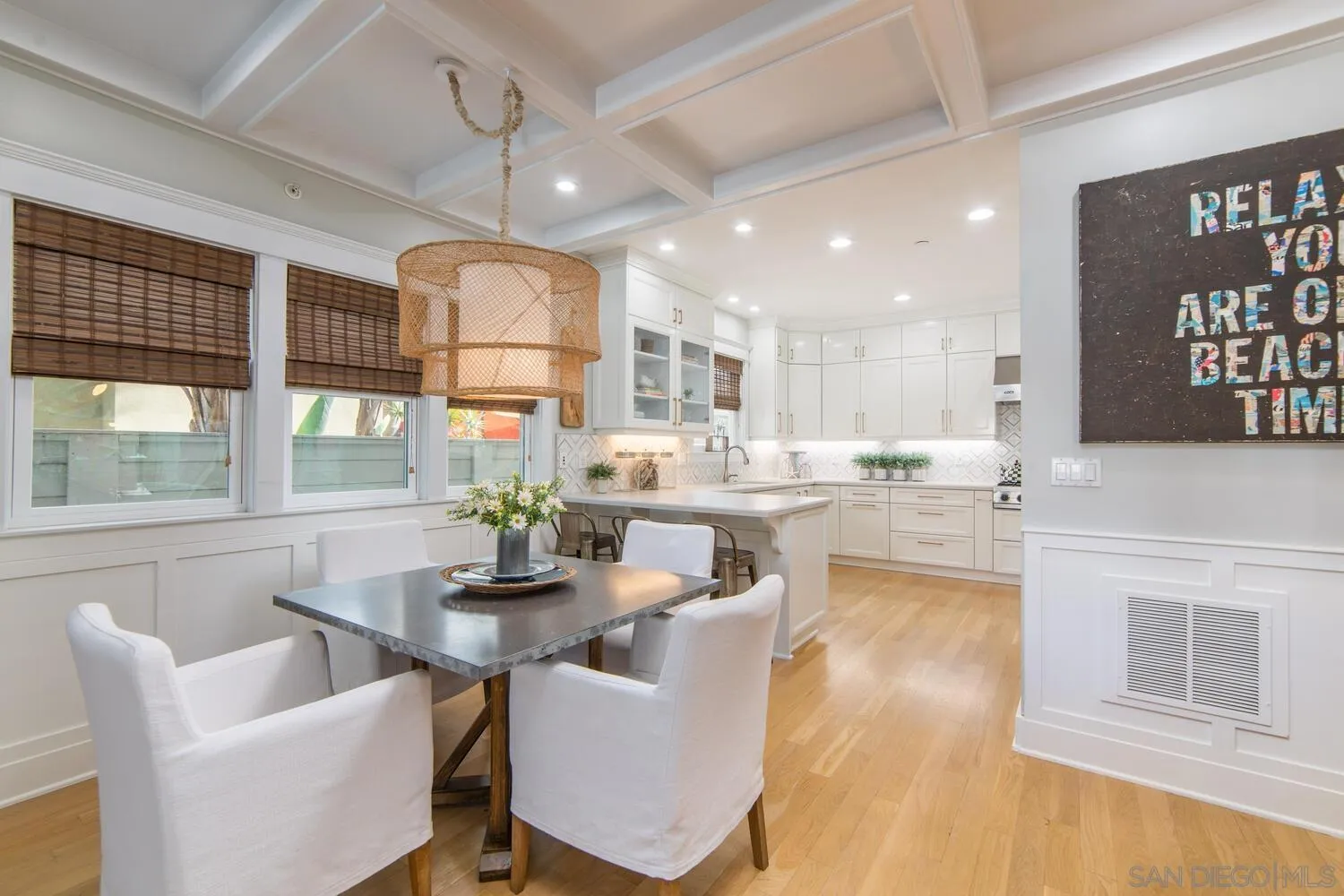717 G Avenue Coronado, CA 92118 - Photo 7 of 33 a dining room with kitchen island furniture a chandelier and a view of kitchen