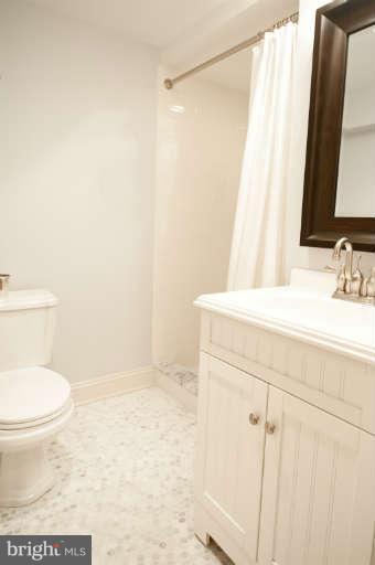 105 Goodale Road Baltimore, MD 21212 - Photo 23 of 27 a bathroom with a sink a toilet and shower