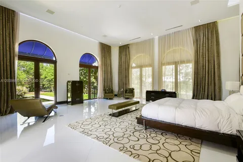 a living room with patio furniture and a large window
