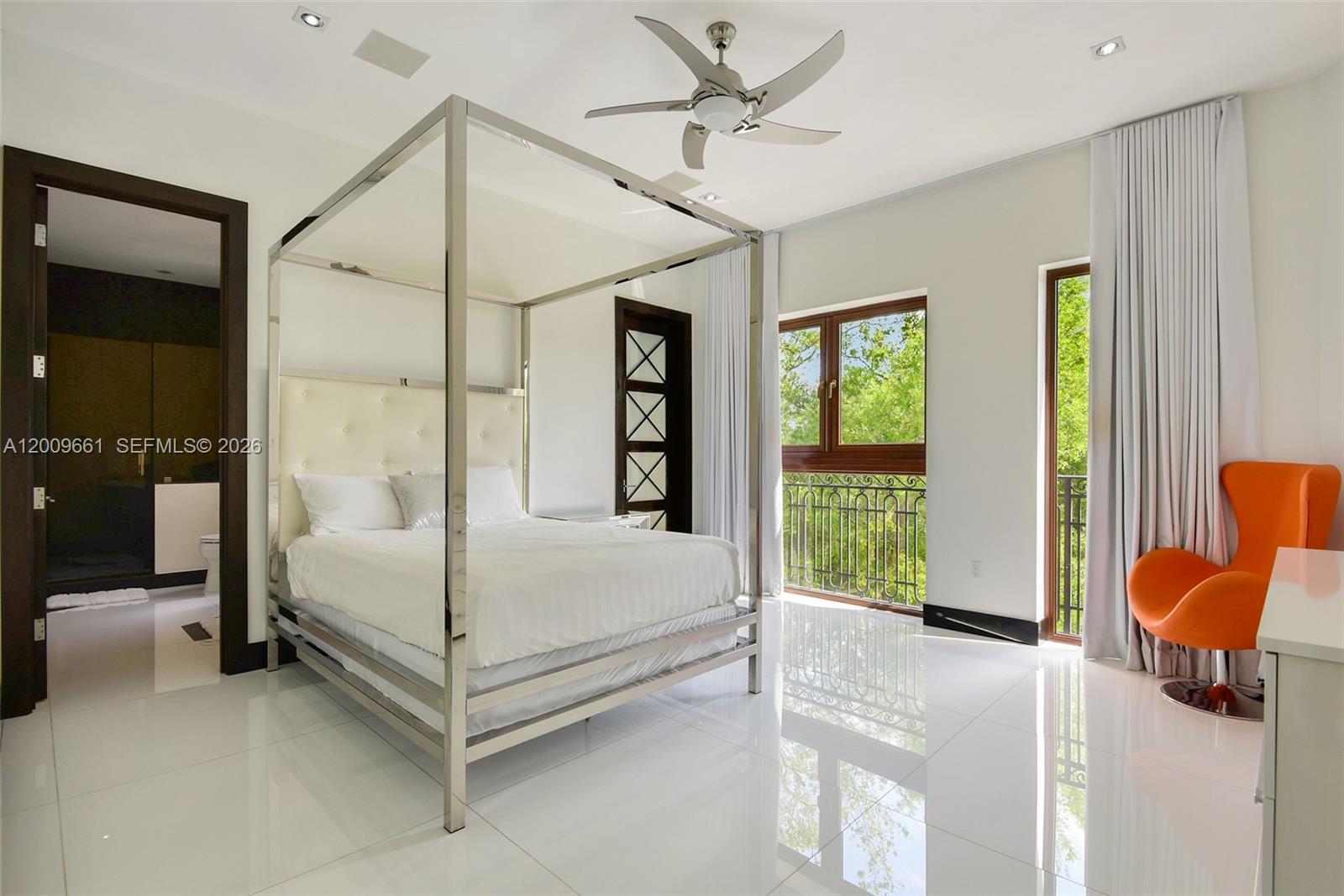 5801 Moss Ranch Road Pinecrest, FL 33156 - Photo 20 of 32 a white bed sitting in a room next to a window