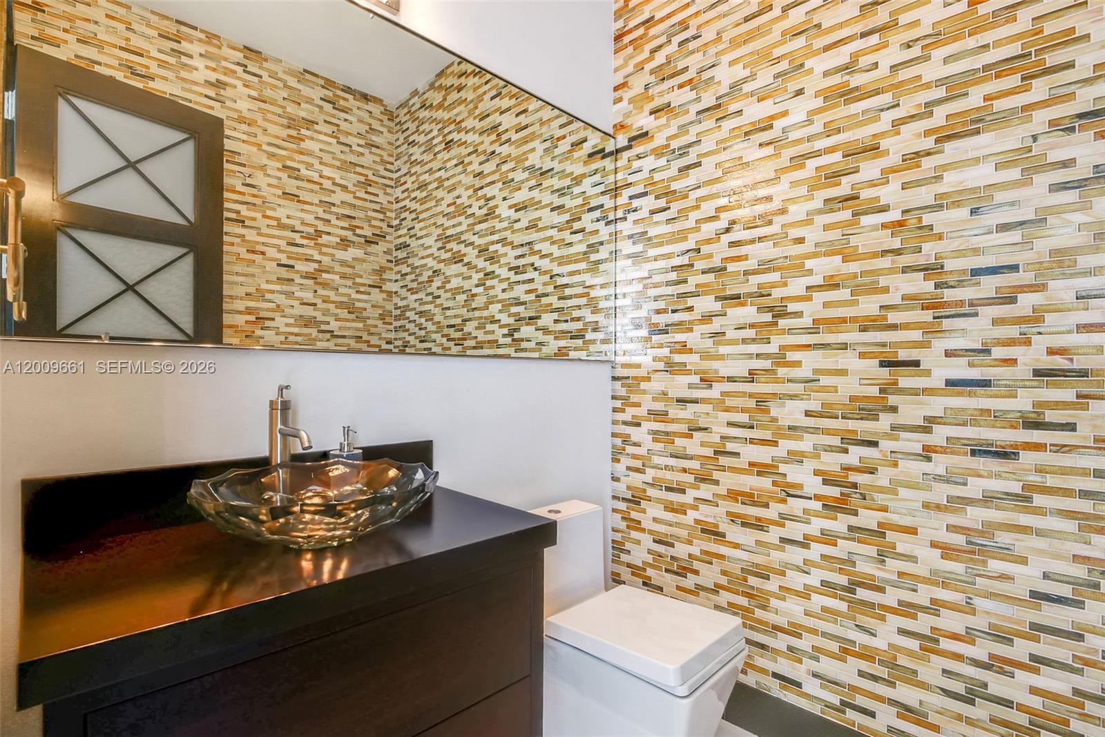 5801 Moss Ranch Road Pinecrest, FL 33156 - Photo 23 of 32 a bathroom with a sink a toilet and a shower curtain