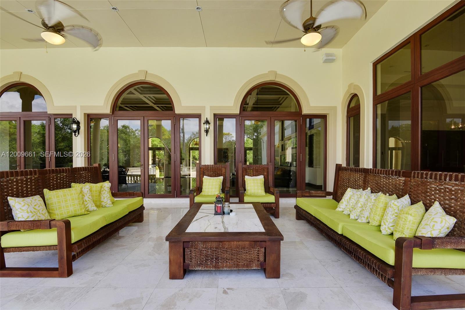 5801 Moss Ranch Road Pinecrest, FL 33156 - Photo 26 of 32 a living room with patio furniture and a large window