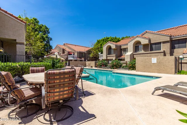 a front view of a house with swimming pool having outdoor seating