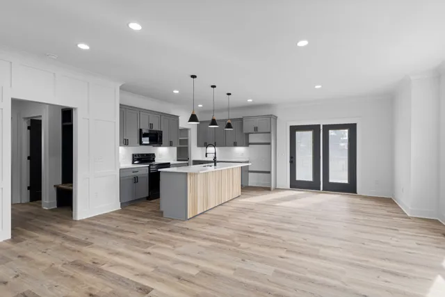 a large kitchen with a refrigerator and a stove top oven