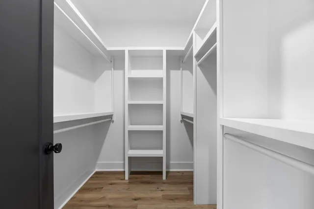 a view of walk in closet with empty racks