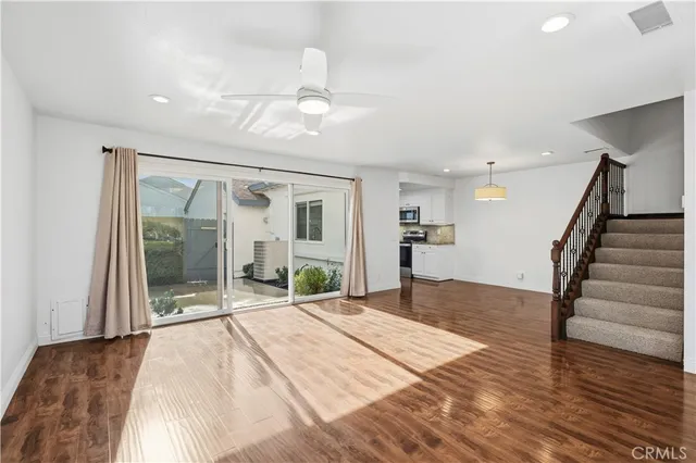 a view of an entryway with wooden floor and livingroom view