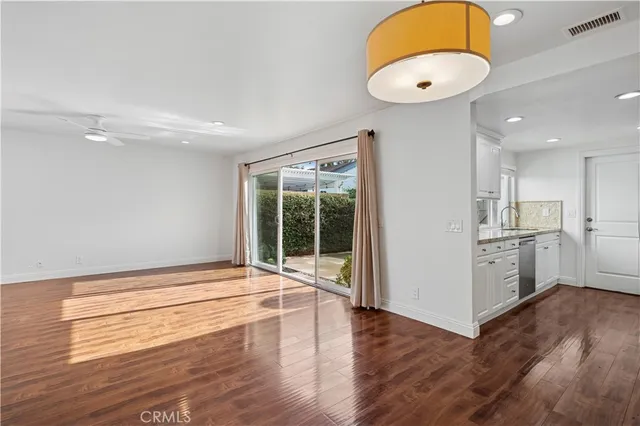 a view of kitchen and hall with wooden floor