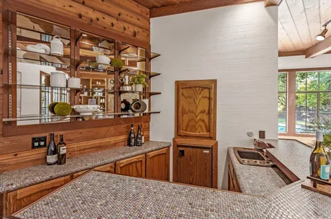 a kitchen with granite countertop sink and cabinets