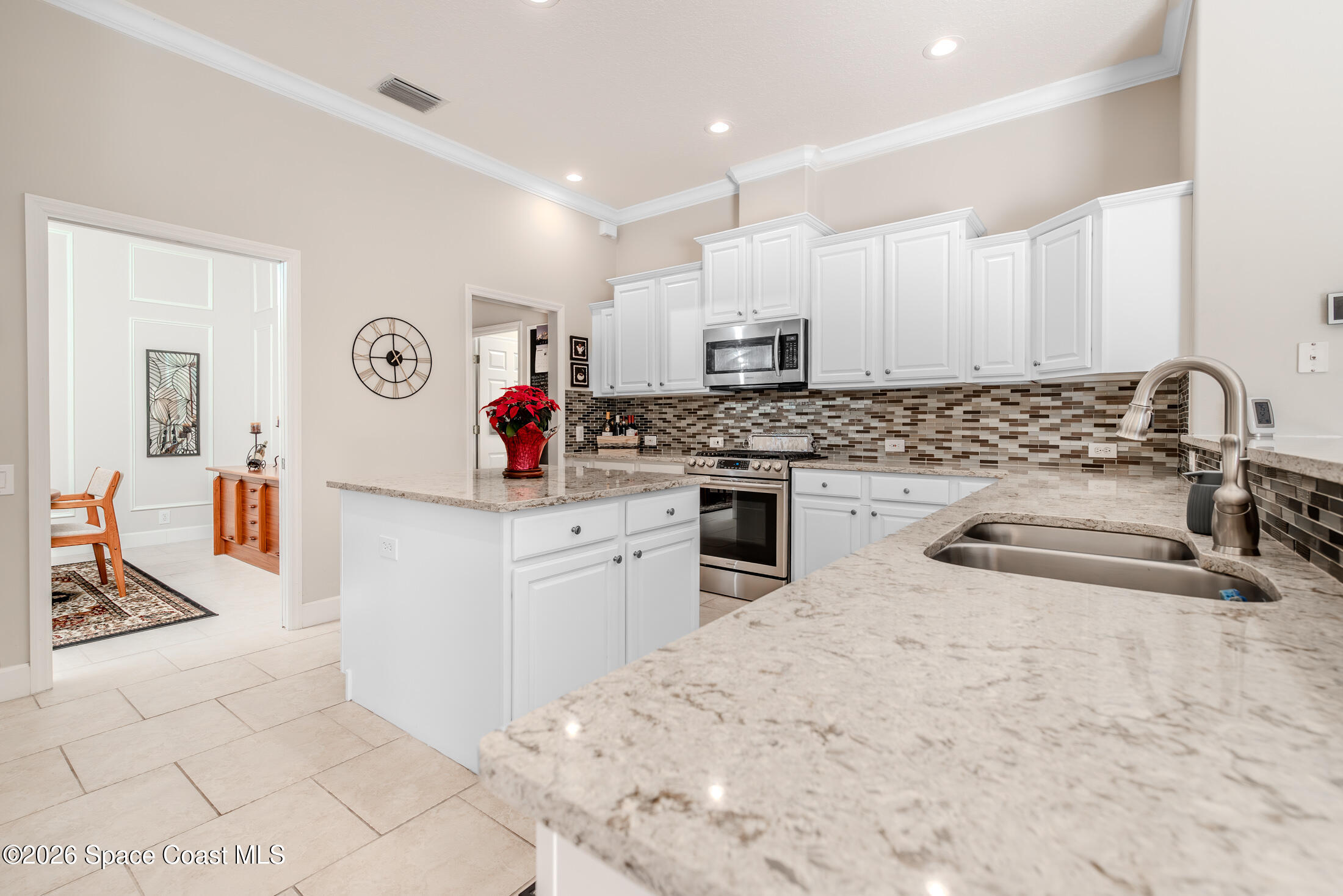 8201 Compton Way Melbourne, FL 32940 - Photo 13 of 52 a kitchen with stainless steel appliances granite countertop a sink stove and cabinets