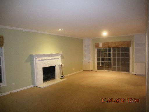 100 Indian Road Lake Bluff, IL 60044 - Photo 3 of 9 an empty room with a fireplace cabinet and window