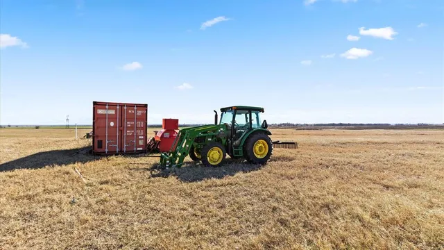 a view of a backyard with wooden fence