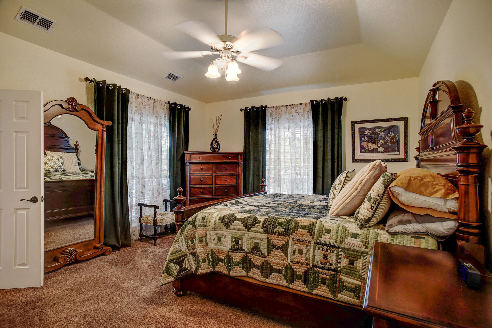 147 Spring Meadow Road Bastrop, TX 78602 - Photo 15 of 40 Bedroom featuring a tray ceiling, ceiling fan with light fixture, and carpet flooring